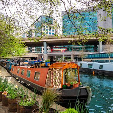 narrowboat moored on the Grand Union canal with flowers outside