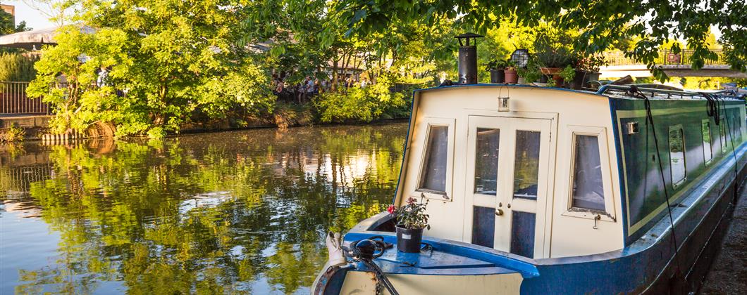 canal boat under a low hanging tree