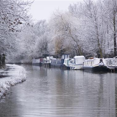 narrowboats riverboats on canal in winter