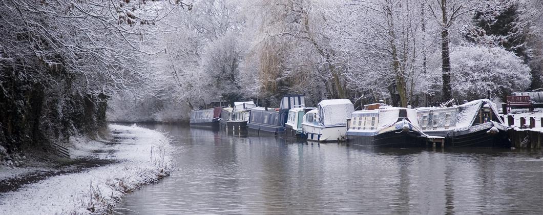 narrowboats riverboats on canal in winter